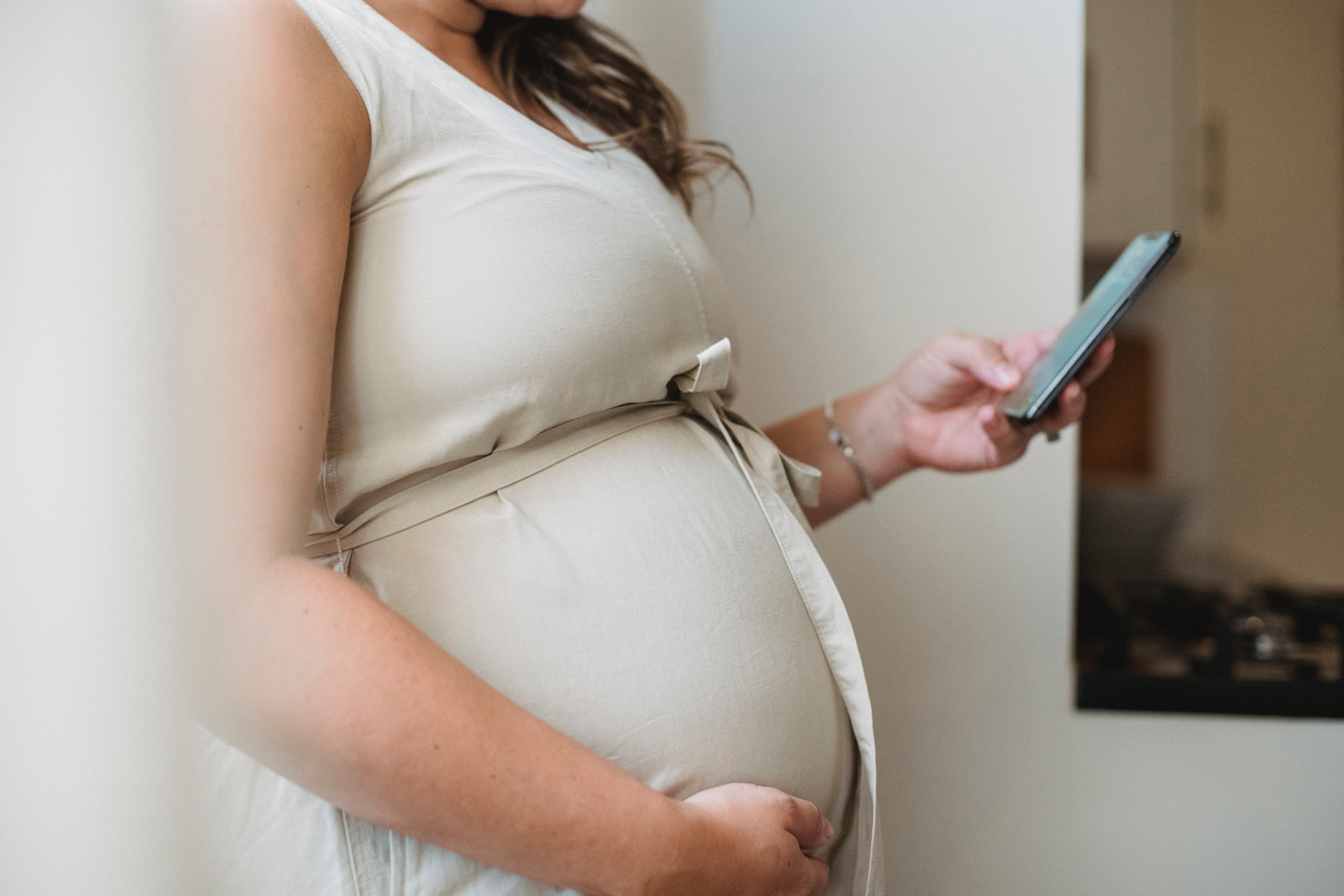 Pregnant woman holding a mobile phone