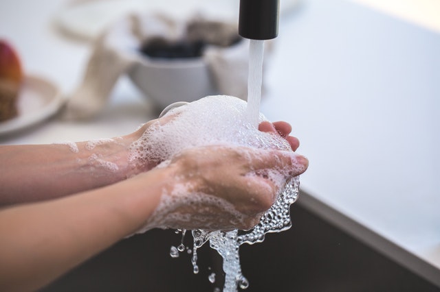 Person washing hands at a sink