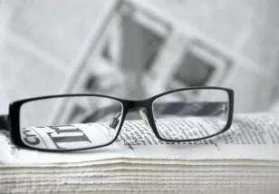 glasses on top of a newspaper