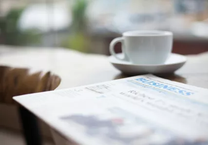 blurred close up of newspaper and coffee