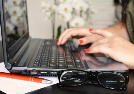 Woman typing on laptop