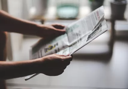 Person holding a newspaper
